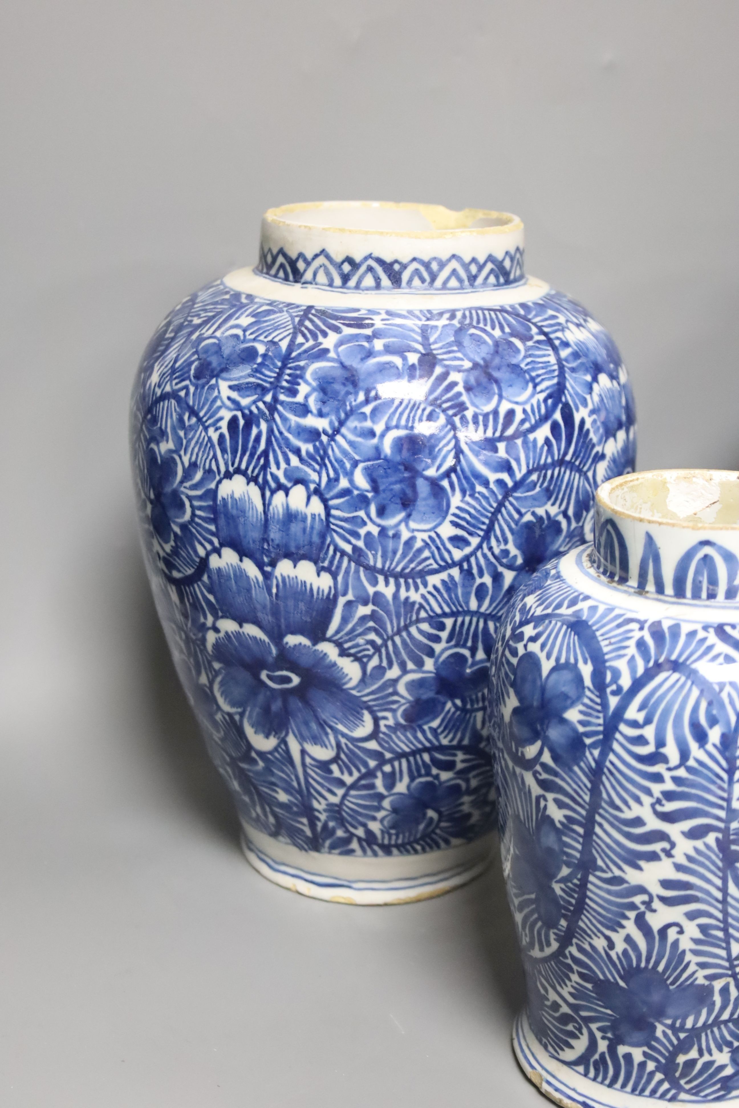 A pair of 18th century Dutch Delft blue and white oviform vases with floral decoration and two similar smaller vases, H 25cm & 19cm